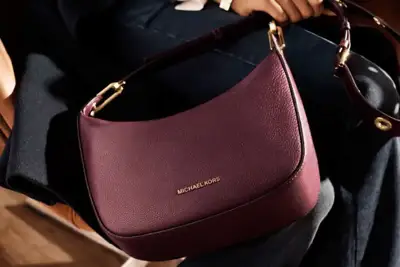 Michael Kors cuts revenue forecast